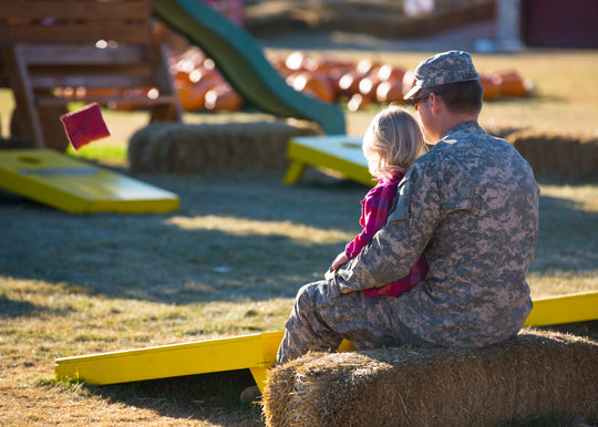 Corn Hole_Military dad girl_sitting on haybale_Hometown Hero.jpg
